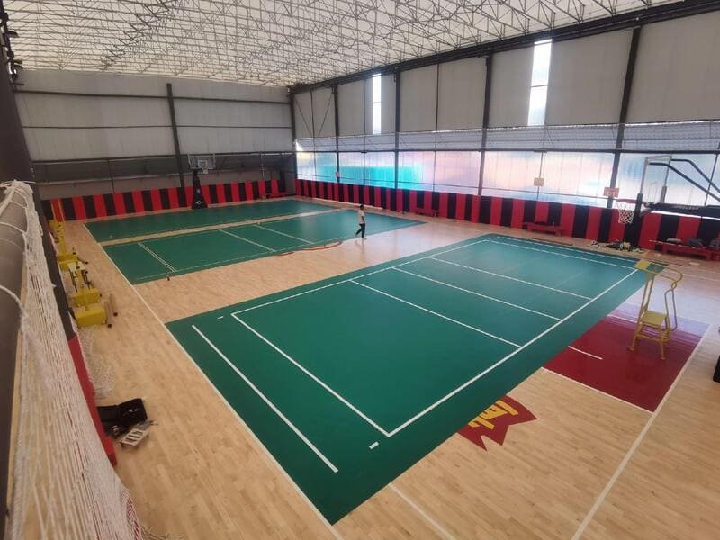 PVC sports flooring roll being measured for waste calculation